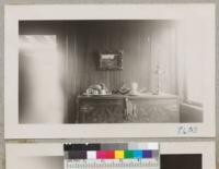 View of panelled walls of Eucalyptus--probably E. viminalis--in the Sherman Leonard home, 876 Southampton St., Palo Alto. The tree grew on the Shim Ranch near Niles on the Centerville road, and was probably 50 years old or more when cut. The boards were air seasoned for 6 months, then dried slowly in a prune dryer for about 15 days by George F. Cleese Mill Work, 826 El Camino, Menlo Park. The lumber has beautiful rippled grain and satiny appearance. Leonard sanded it after it was in place. December 1951. Metcalf