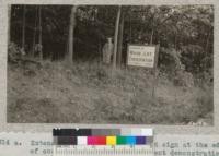 Extension Forester Kroodsma and sign at the edge of one of his woodlot improvement demonstrations in central Michigan near Greenfield. 1932. Metcalf