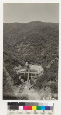 Concrete dam and reservoir with water measuring devices and a typical brush covered watershed of the Bell Canyon series at San Dimas Experimental Forest, Los Angeles County