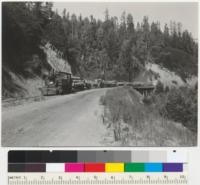 Redwood log train, Caspar Lumber Company, on way to Caspar from Chamberlain Creek Camp #20. Along Willits-Ft. Bragg road, near 2-log creek. 8-14-41. E.F