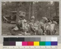 Picnic of Forest Service people of Asheville, N.C. at Asheville Auto Camp ground June 8, 1924. Director Frothingham of the Experiment Station is talking to Forest Supervisor Rogers while Korstian is passing food around to the crowd