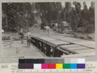 Bunger, Harris, and Collins making a tally for a millscale study, near Camp Califorest. The lumber is conveyed from the sawmill about 1000 ft. away and then elevated to this table. Spanish Peak Lumber Company. July, 1926