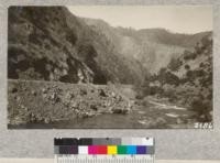 The new highway grade below Ned's Gulch, Merced River Canyon showing a part of the area burned in 1924. Some of the trees were killed or injured by this fire but most will survive. If the canyon can be successfully protected from fire, the present scattered growth of trees will gradually seed up the slopes. Planting is needed only on exposed points where fires have been exceptionally severe or to cover the sides of cuts. The broken rock fills below the highway grade will not support any trees or shrubs until they have been gradually filled with earth. Planting on these in their present condition is out of the question