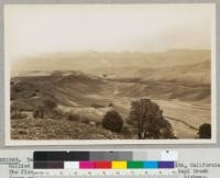 Tehachapi Flood Area. September 30, 1932. Gullied hillsides and cut stream channel south of Monolith, California. The flood waters converging from three slopes into Tehachapi Creek (near smoke) caused 5 million dollars damage to railroad, highway, power lines, and the death of 32 persons. October, 1932