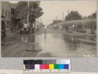 Elk Grove fire truck under leadership of Chief Cann throwing water from a small nozzle on a chemical hose. Metcalf. 1928