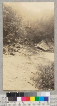 Slippage of over-wet soil caused the collapse of a two-story house across the road from the Topanga Patrol Station of the Los Angeles County Forestry Department. March 1938. Metcalf