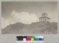 Top of Red Mountain, Columbia National Forest, with lookout station and flag. A fine view of the snow peaks of the Cascades may be had from this point