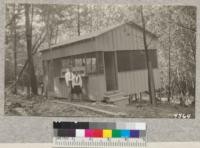 The cookhouse at Las Posadas Forest during the construction period, May, 1928. Beatrice and Everett Stanford in foreground. The six counties raised $600 for improvements at the camp this year. Metcalf