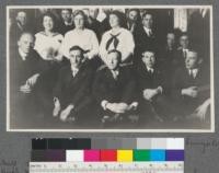 Forestry Club gathering in the Bungalow, University of California, 1916. Front row: Metcalf, Burton, Pratt, Muzzall [?], Ryerson. 2nd row: Prof. Kennedy, Mrs. Metcalf, Mrs. Mulford, Mrs. Pratt, Hall, Dunning [?], ?. Back row: Wieslander, Holmes, Hansen, [no more names in caption]