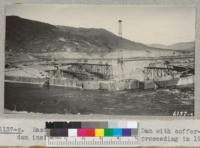 East portion of Grand Coulee Dam with cofferdam inside which construction is proceeding in 1937