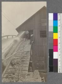 Washing logs before they enter the mill. (V. Davis seated in window). Spanish Peak Lumber Company, Quincy, California. August, 1920. E.F