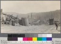 Northwestern Pacific Railroad siding at South Fork near Dyerville, Humboldt County, California. This point is used as shipping point for small operators in redwood split stuff. Note the signs suspended from wire, allotting space along tracks to each operator, to avoid having one or two hog all the space. May, 1920. E. F