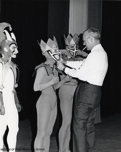 Lew Christensen adjusting the headpiece for one a dancer for his piece "Jest of Cards"