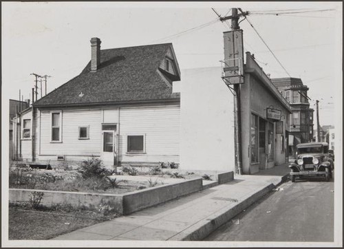 Bakery and laundry near storefront of old residence, south side of West 23rd Street, west of Union Avenue