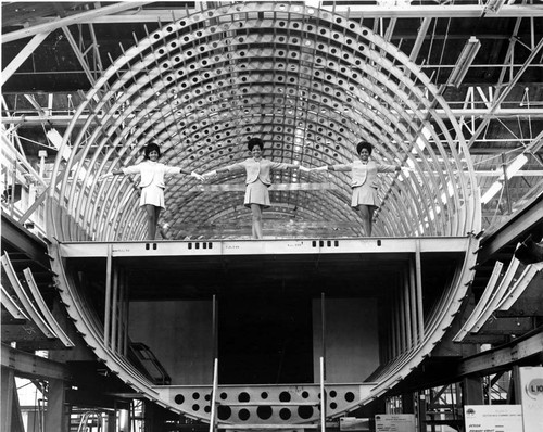 Air Jamaica stewardesses in L-1011 airplane under construction, Lockheed plant, Burbank, 1969