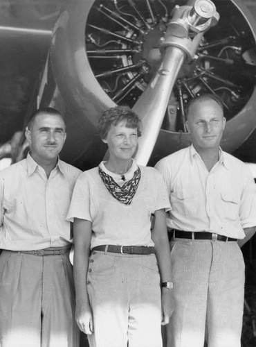 Paul Mantz, Amelia Earhart, and Marshall Headle, Lockheed Test Pilot, with the Earhart Vega in the Background, at United Airport