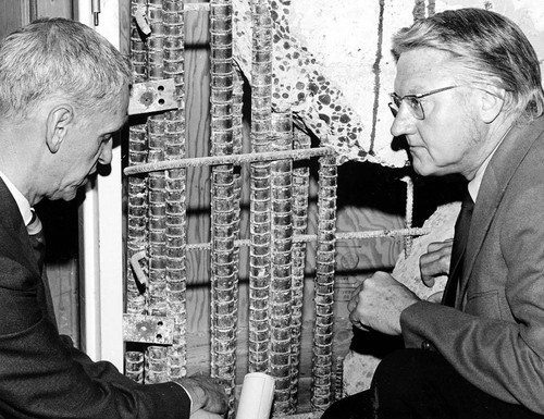 Congressman James C. Corman examining earthquake damage, Panorama City, 1971