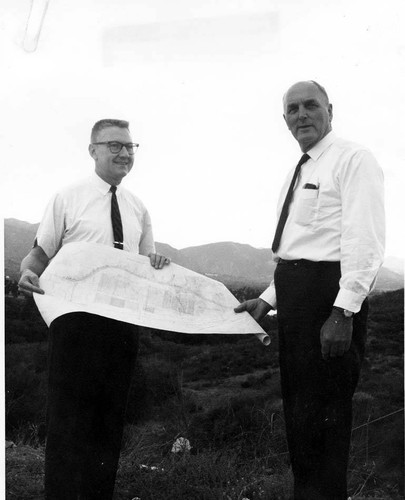 Congressman James C. Corman and Metropolitan Water District manager Henry J. Mills with water treatment plant plans, Sylmar, circa 1967