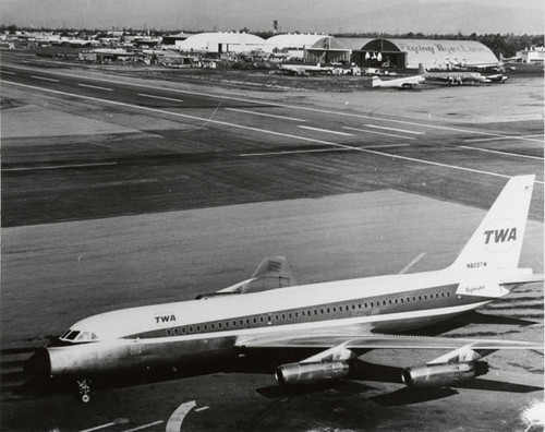 Lockheed L-1049 Constellation which was owned and operated by the Flying Tiger Line; in the foreground is TWA's Convair 880