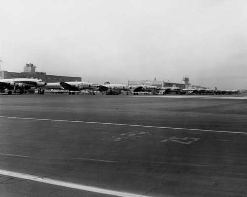 Airplanes lined up for non-scheduled flights, last day of the "Non-Skeds," Lockheed Air Terminal, Burbank, 1962