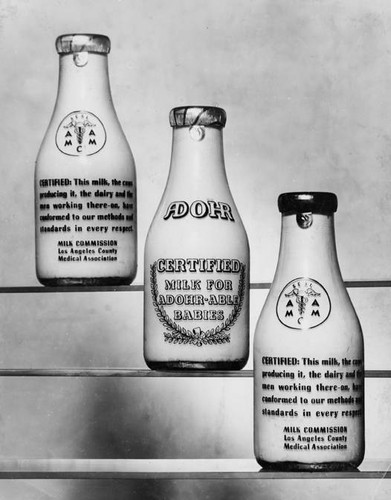 Adohr Farms' Certified Milk in bottles shown with their guarantee on the back, circa 1936