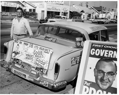 Car decorated with campaign signs and stickers, San Fernando Valley, 1958