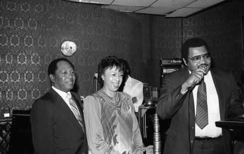 J.B. Stone speaking into a microphone at the Pied Piper nightclub, Los Angeles, 1983