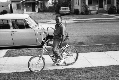 Reggie Crowder posing on a bicycle, Los Angeles, ca. 1980