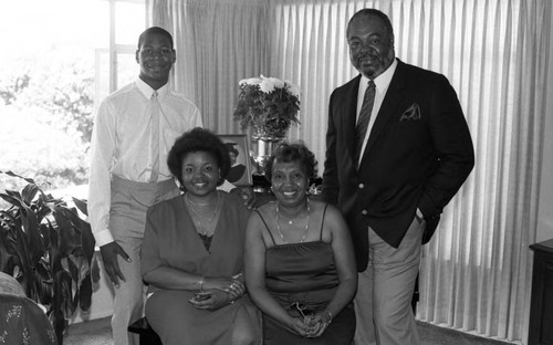 Young woman posing with her family after graduation, Los Angeles, 1985