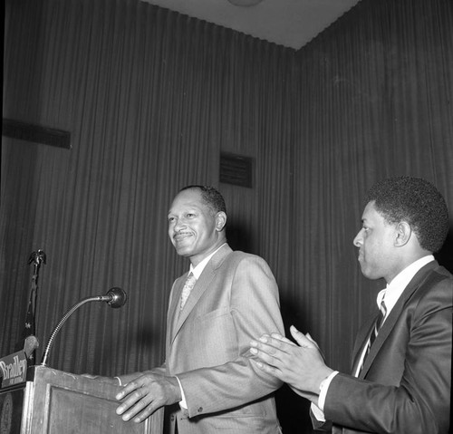 Tom Bradley standing at a lectern during his mayoral campaign, Los Angeles, 1969