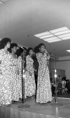 Young women singing on a stage, Los Angeles