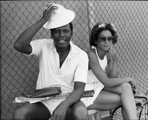 Sidney Poitier and Freda Payne prepare for tennis, Los Angeles, ca. 1976