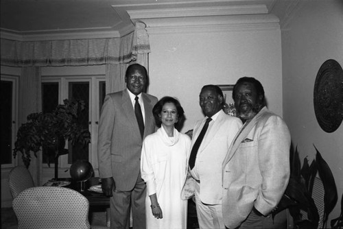 Tom Bradley posing with Clarence Avant and others at a fundraiser, Los Angeles, 1985