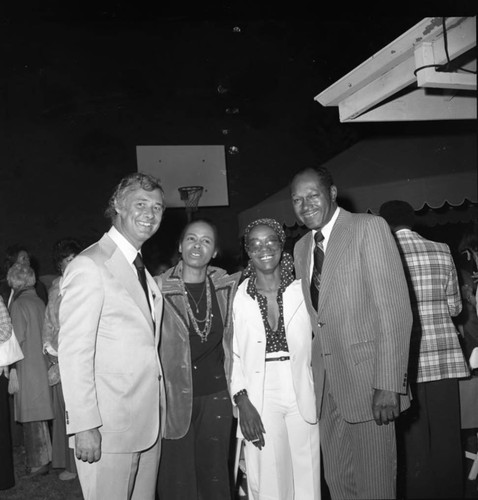 Tom Bradley posing with others at one of his mayoral campaign events, Los Angeles, 1973