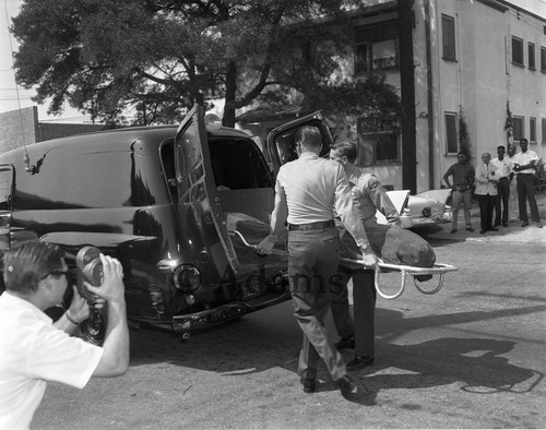 Loading medical vehicle, Los Angeles, 1964