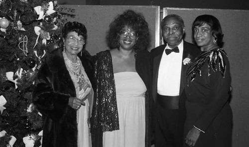 Dr. Cecil L. Murray posing with guests at a First AME Church fund raiser, Los Angeles, 1989