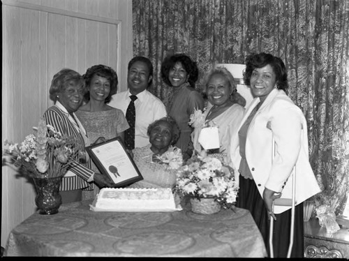 Rev. Dacco posing with others at a celebration, Los Angeles, 1983