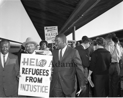 Rev. Maurice Dawkins welcoming a displaced Louisiana family, Los Angeles, 1962