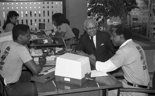 Founders Savings and Loan staff member helping a client, Los Angeles, 1989