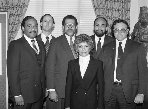 David S. Cunningham, Jr. and others posing for a group portrait with an unidentified woman, Los Angeles, 1983