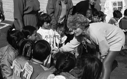 Woman talking to children at a Head Start Toy Lift event, Los Angeles, 1993