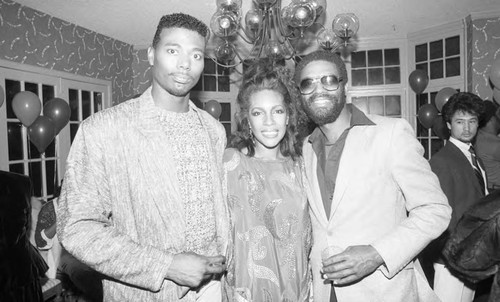 Mary Wilson posing with guests at her birthday party, Los Angeles, 1985