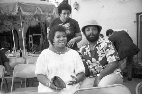 Andraé Crouch posing with a woman at a Los Angeles Press Club event, Los Angeles, 1983