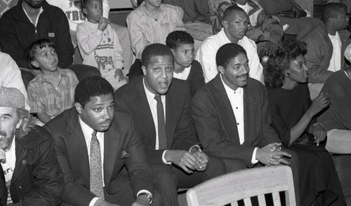 Jamaal Wilkes and Norm Nixon sitting among a crowd, Los Angeles, 1988