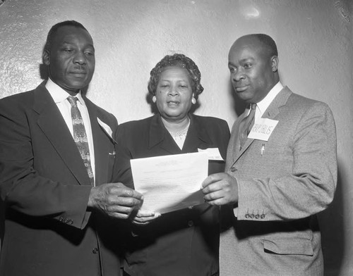 Two men and one woman at luncheon, Los Angeles