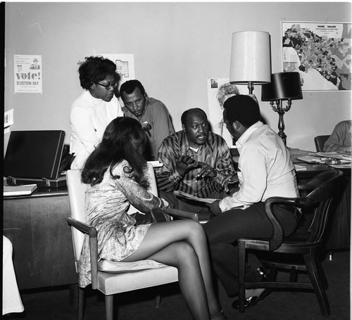 Samuel McNeal, Jr. and Lois Felder talking with others at the A. Philip Randolph Institute office, Los Angeles, 1972