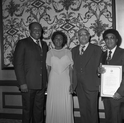 Willie Davis posing with Curtis Tucker and others at a Brotherhood Crusade dinner, Los Angeles, 1978