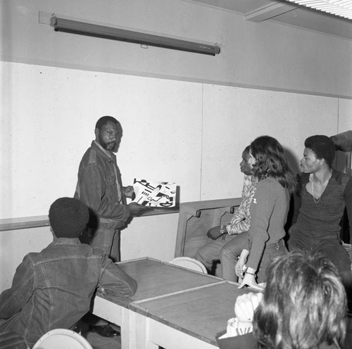 Instructor discussing a design with students during Career Day at Compton College, Compton, 1973