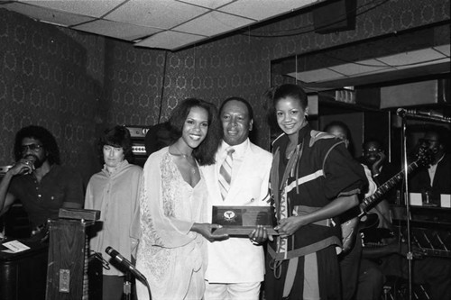 Deborah Burrell and Susan Beaubian posing with Freddie Jett at the Pied Piper nightclub, Los Angeles, 1983