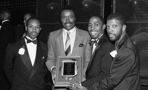 Jim Hill posing with an award, Los Angeles, 1989